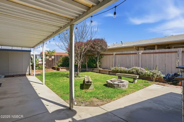 a view of a backyard with a sitting area