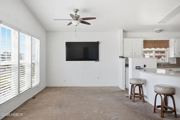 a view of a livingroom with furniture and windows