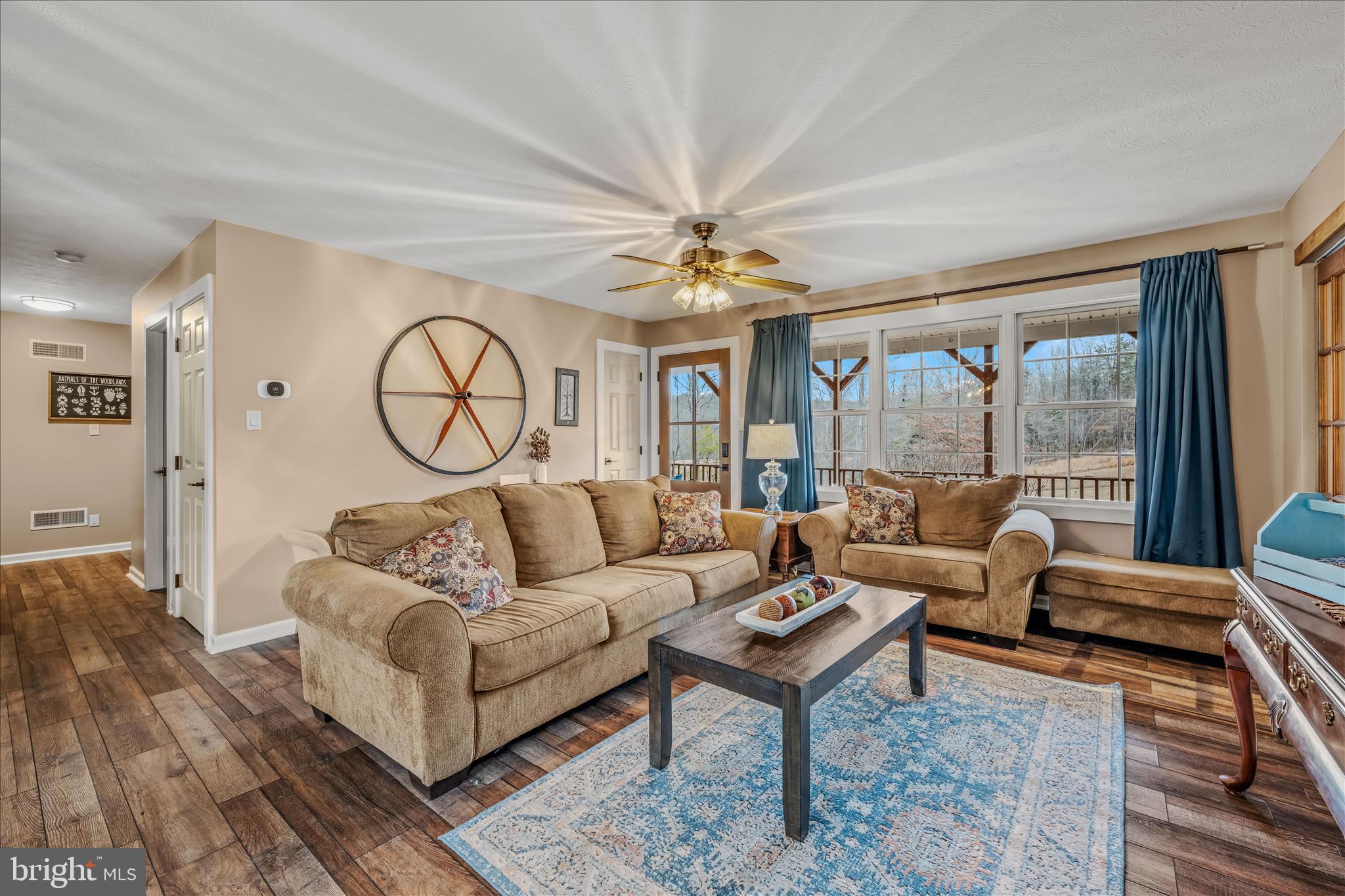 1636 Eckerd Lane Berkeley Springs, WV 25411 - Photo 14 of 85 a living room with furniture a large window and a chandelier