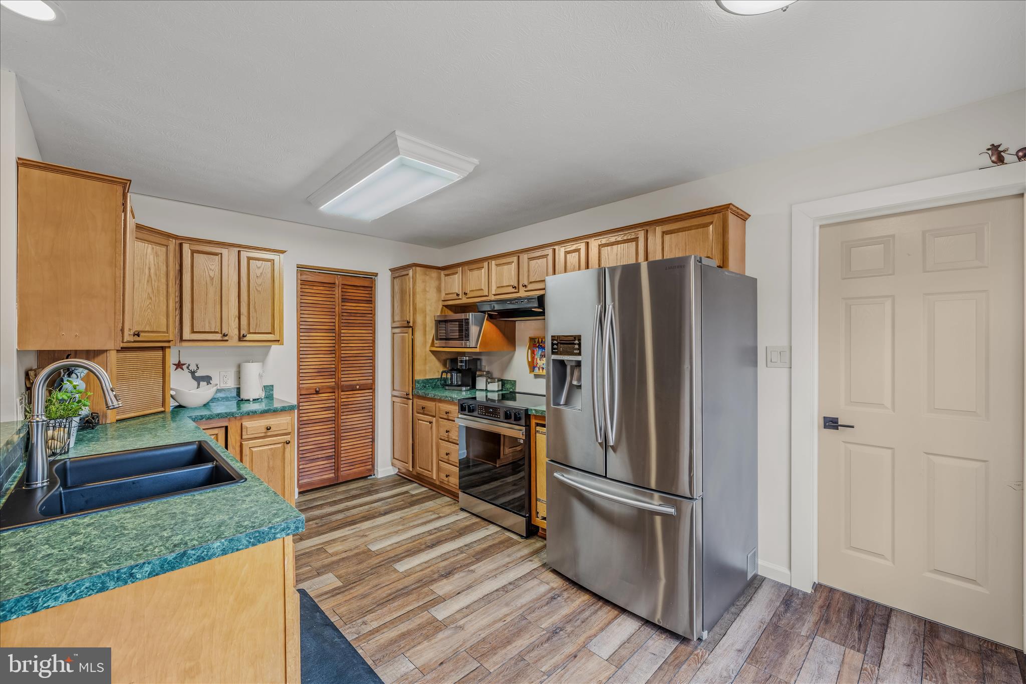 1636 Eckerd Lane Berkeley Springs, WV 25411 - Photo 20 of 85 a kitchen with a refrigerator and a sink