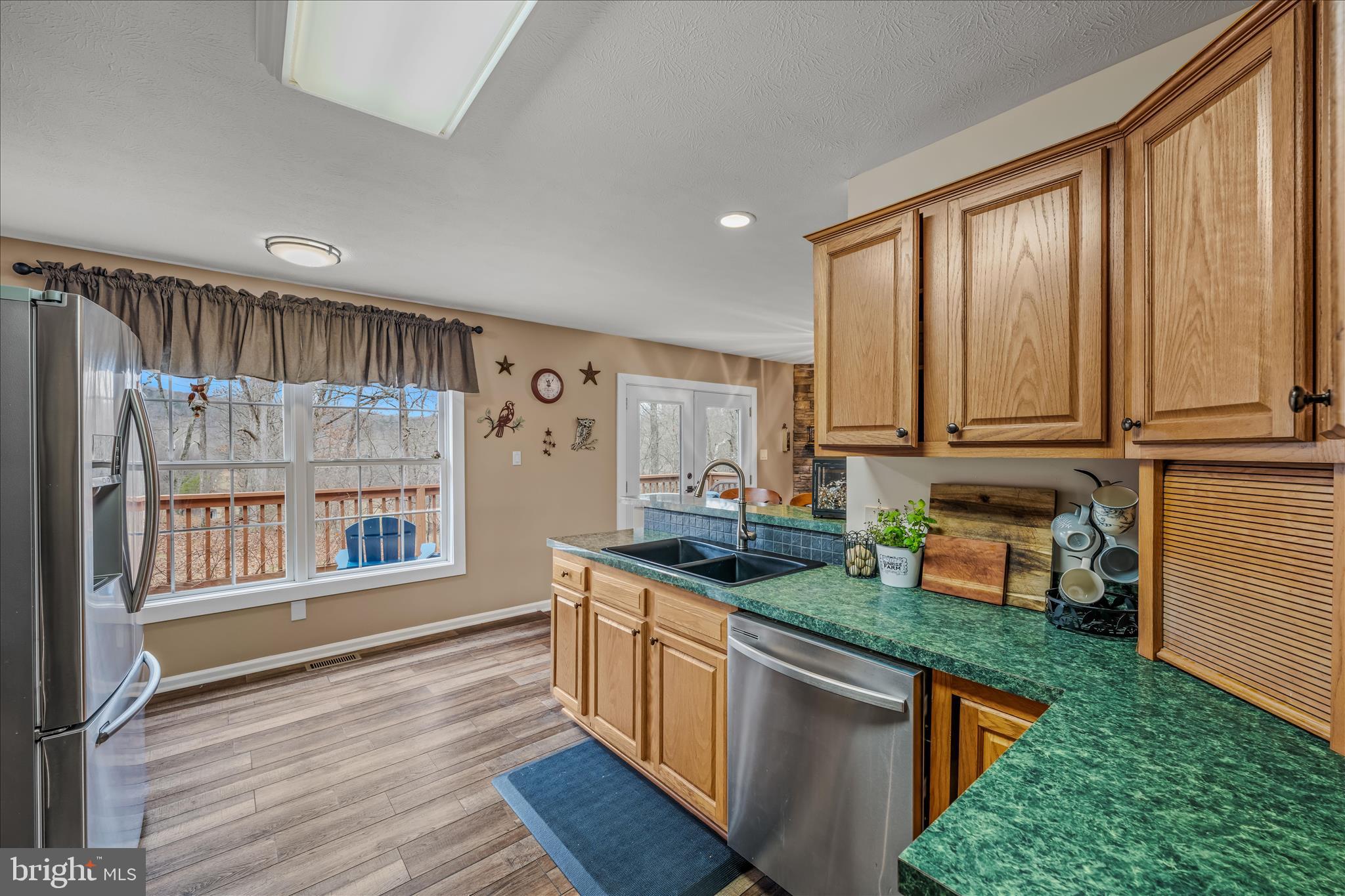1636 Eckerd Lane Berkeley Springs, WV 25411 - Photo 22 of 85 a kitchen with stainless steel appliances granite countertop a stove a sink and a refrigerator