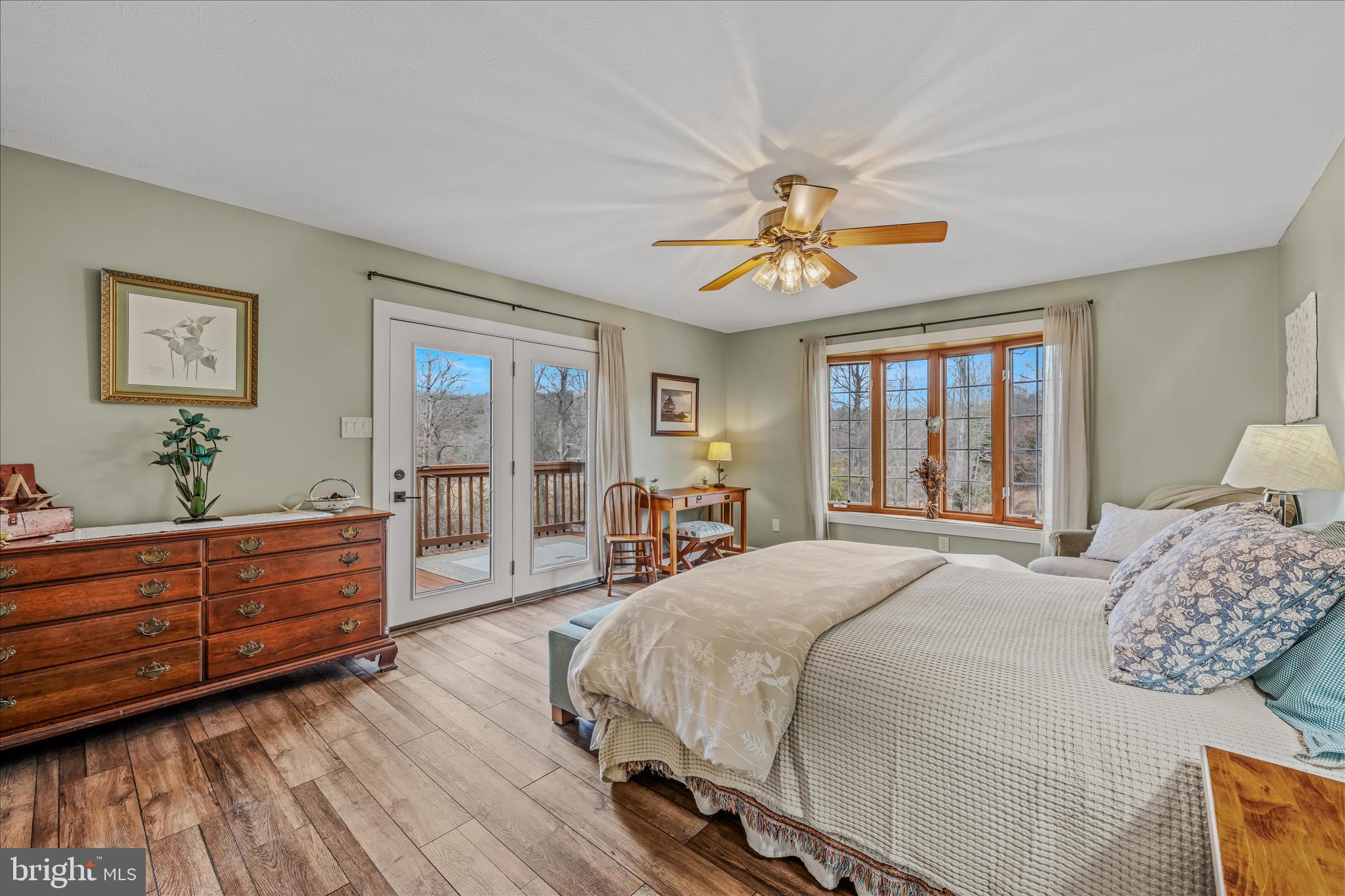 1636 Eckerd Lane Berkeley Springs, WV 25411 - Photo 31 of 85 a spacious bedroom with a large bed and a chandelier