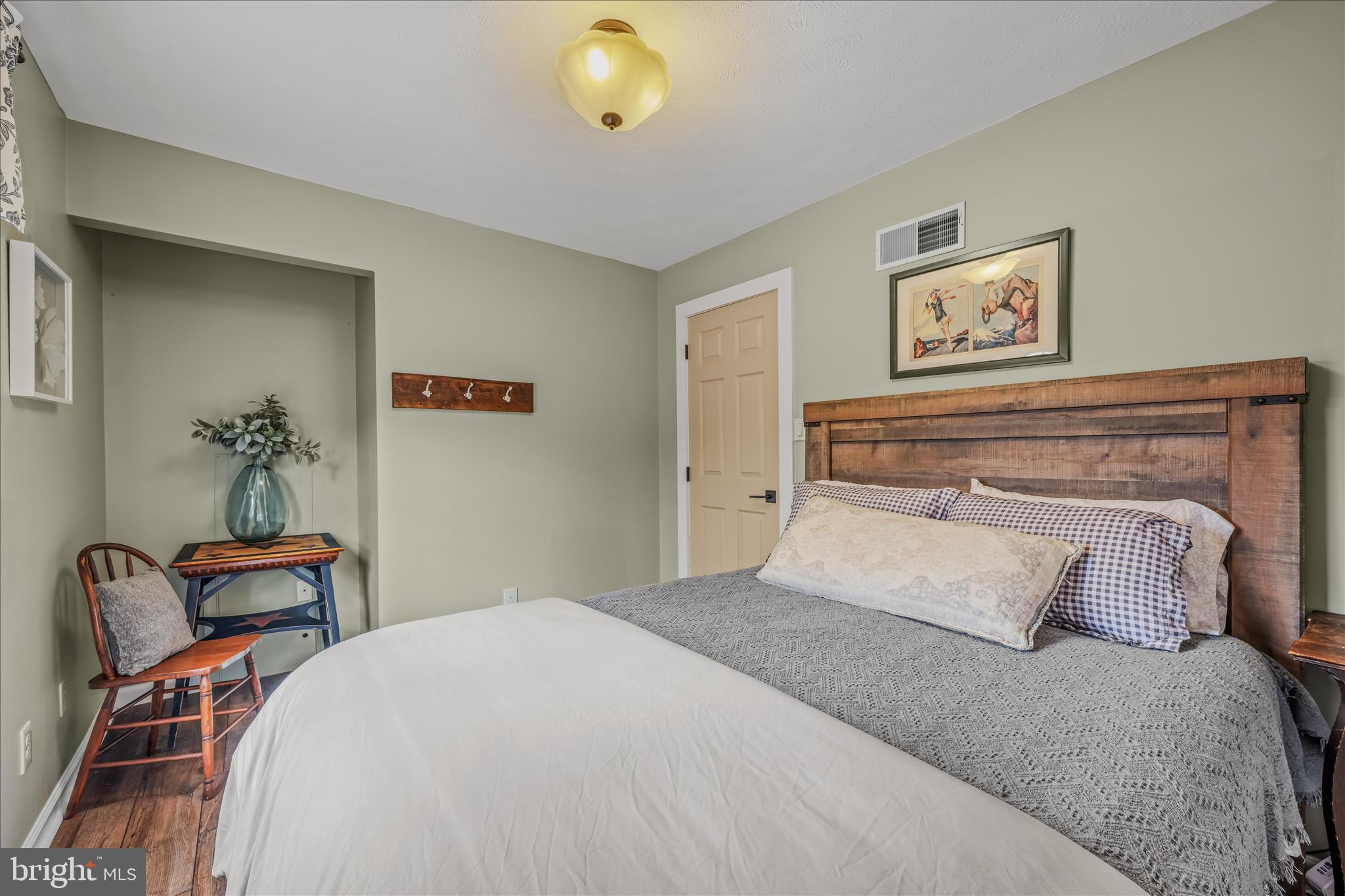1636 Eckerd Lane Berkeley Springs, WV 25411 - Photo 41 of 85 a bedroom with bed and painting on the wall