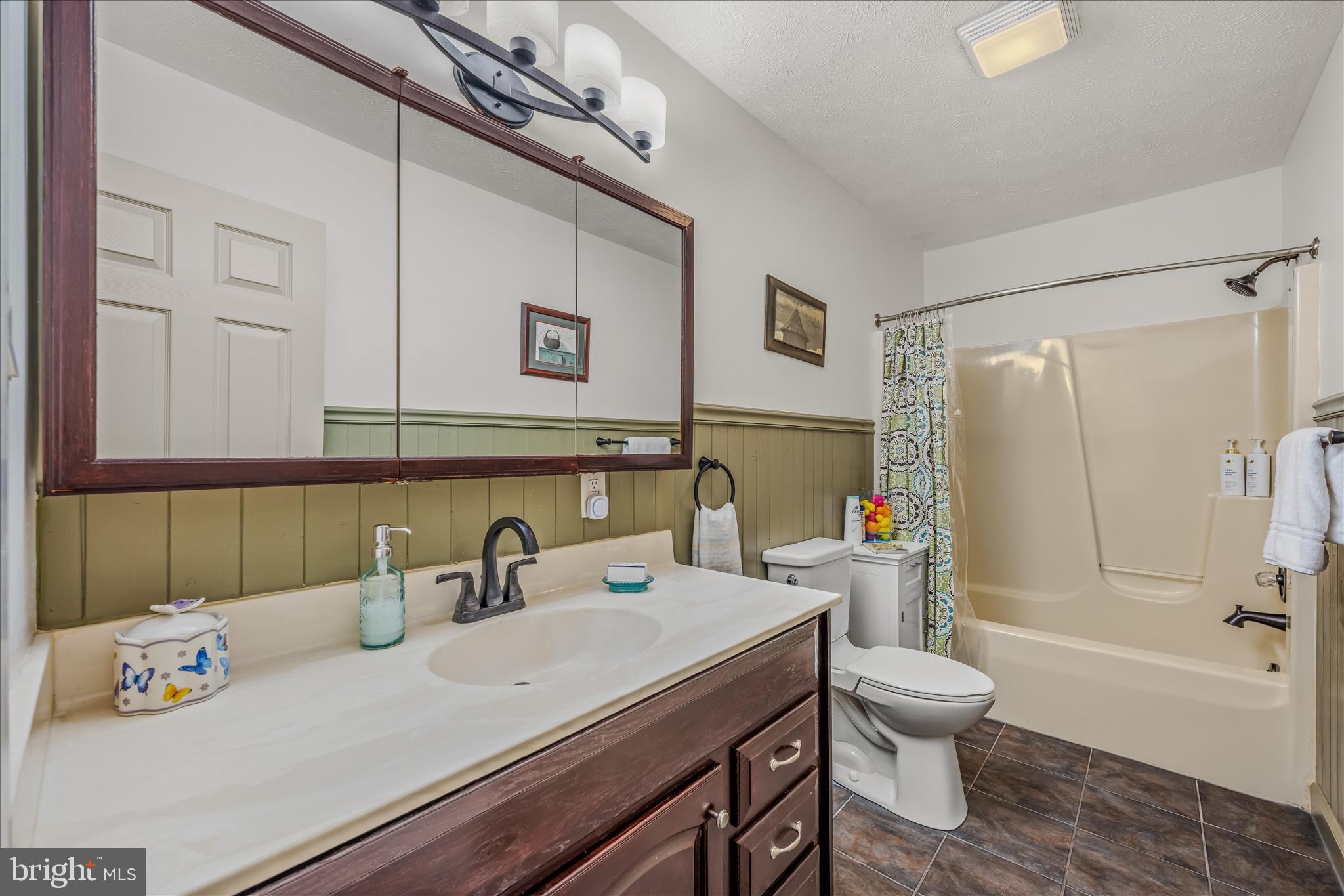 1636 Eckerd Lane Berkeley Springs, WV 25411 - Photo 42 of 85 a bathroom with a sink a toilet and shower