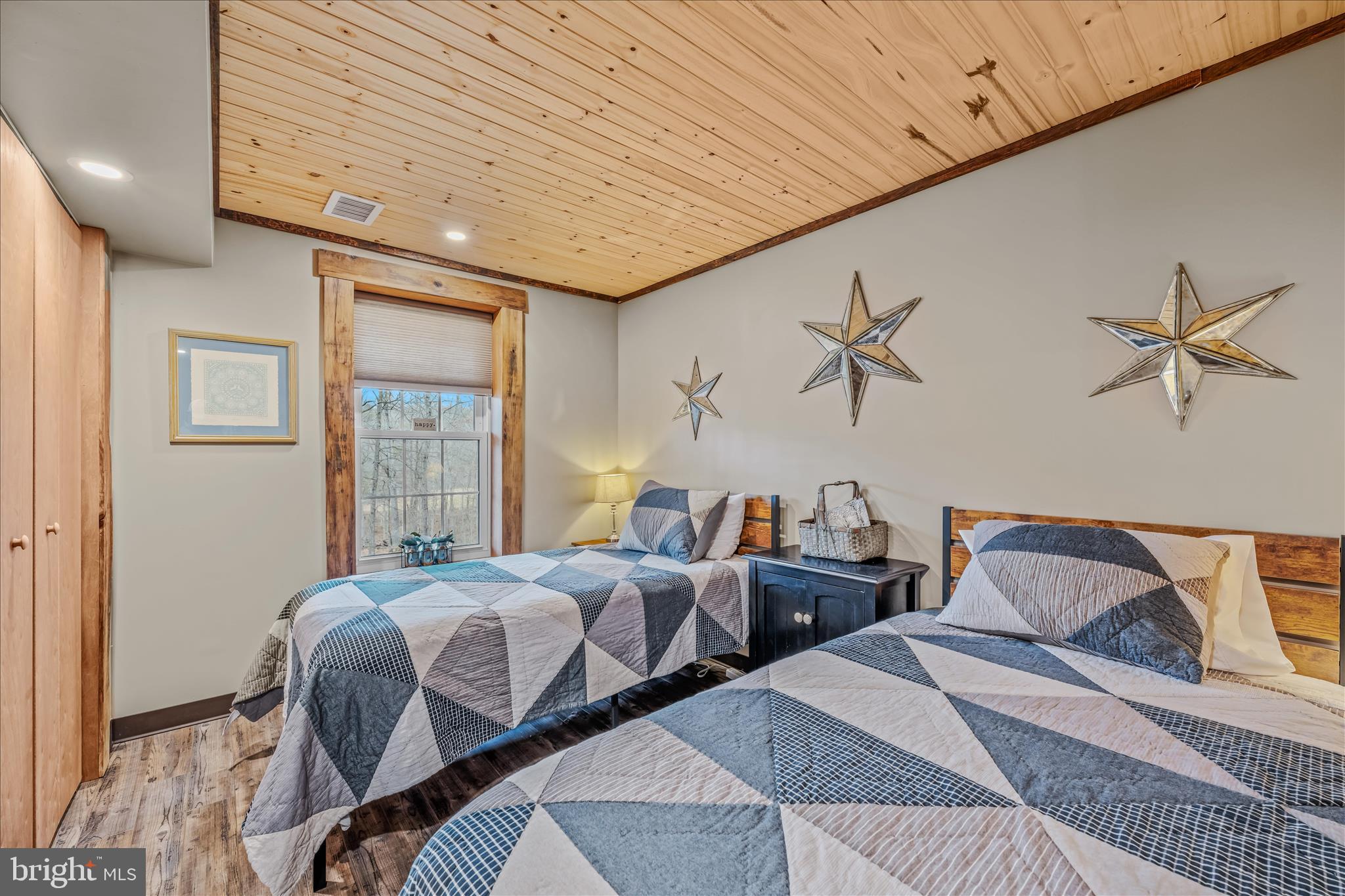 1636 Eckerd Lane Berkeley Springs, WV 25411 - Photo 52 of 85 a bedroom with two beds and a chandelier