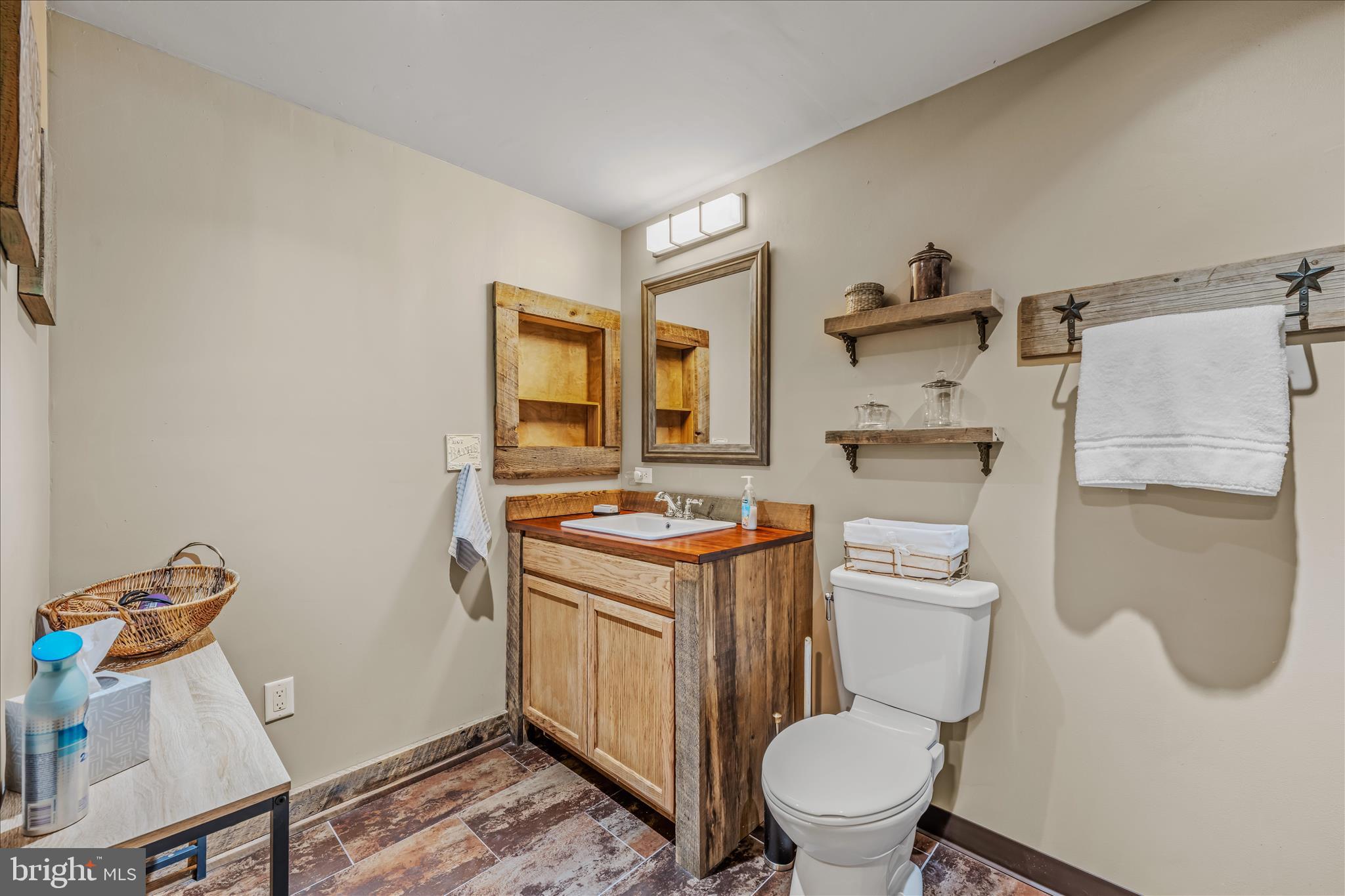 1636 Eckerd Lane Berkeley Springs, WV 25411 - Photo 54 of 85 a bathroom with a toilet a sink and a mirror