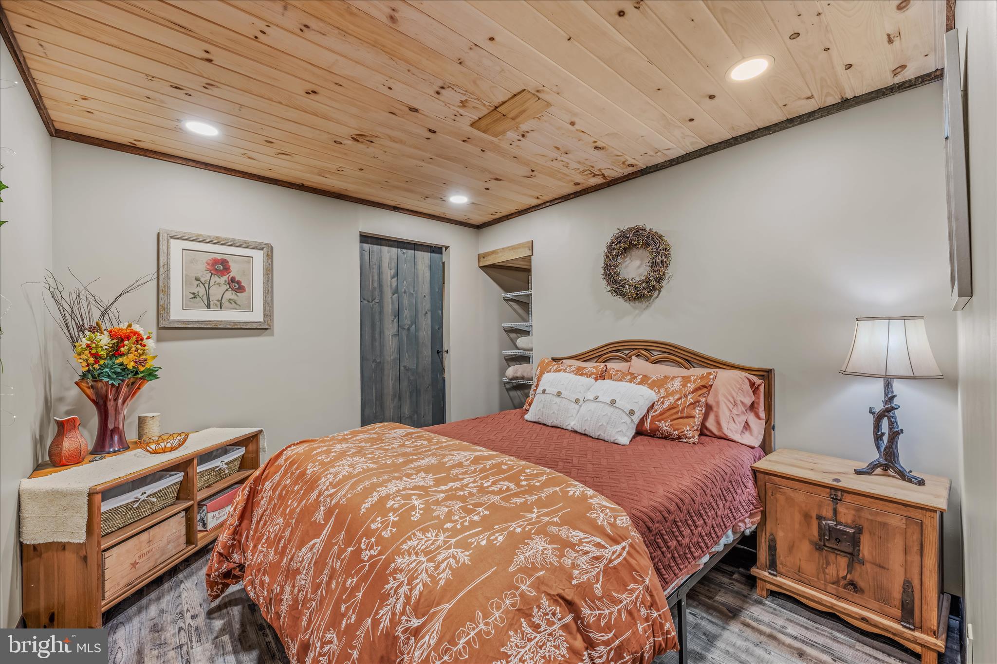 1636 Eckerd Lane Berkeley Springs, WV 25411 - Photo 57 of 85 a bedroom with a bed and a chandelier