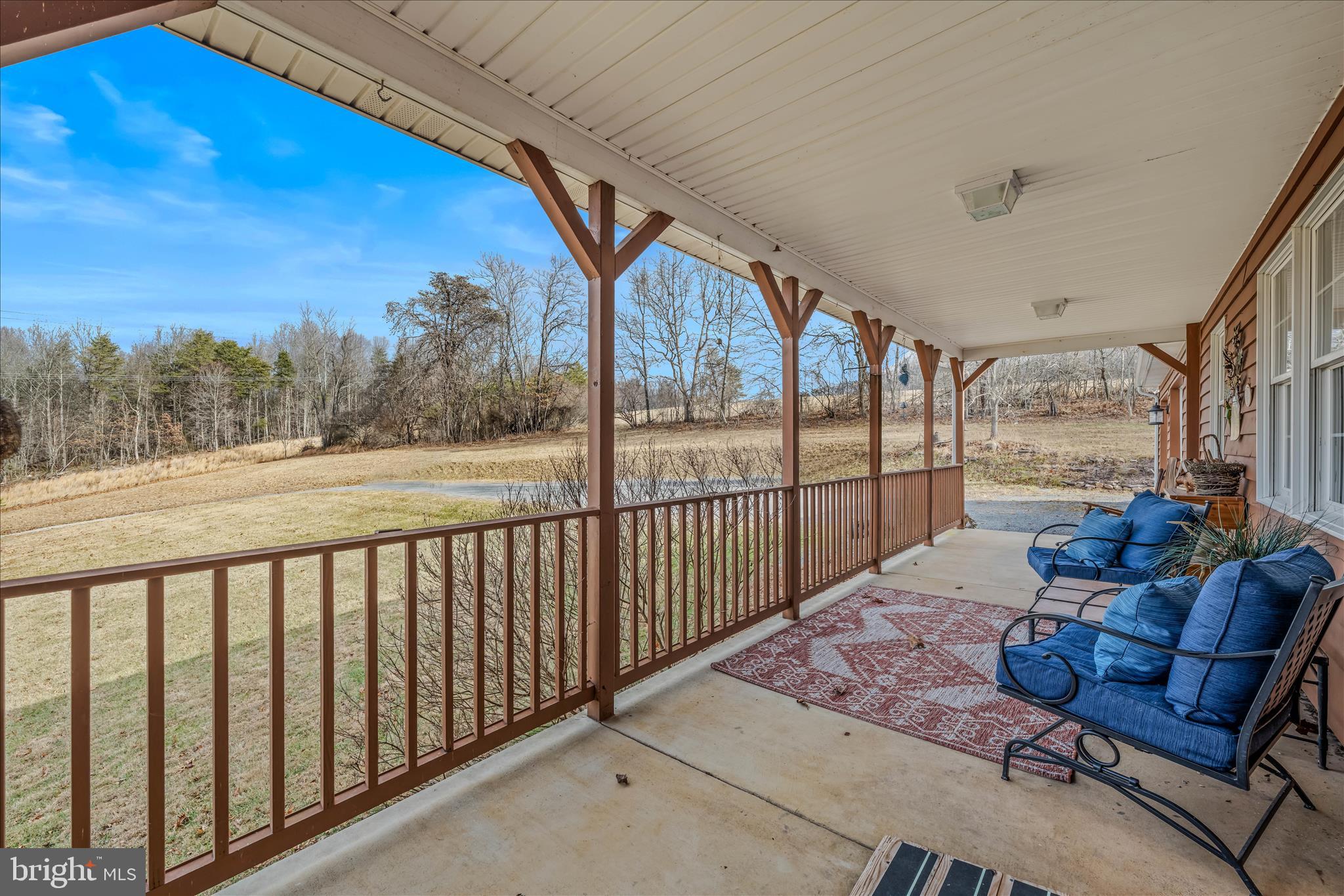 1636 Eckerd Lane Berkeley Springs, WV 25411 - Photo 9 of 85 a balcony with furniture and a view of lake