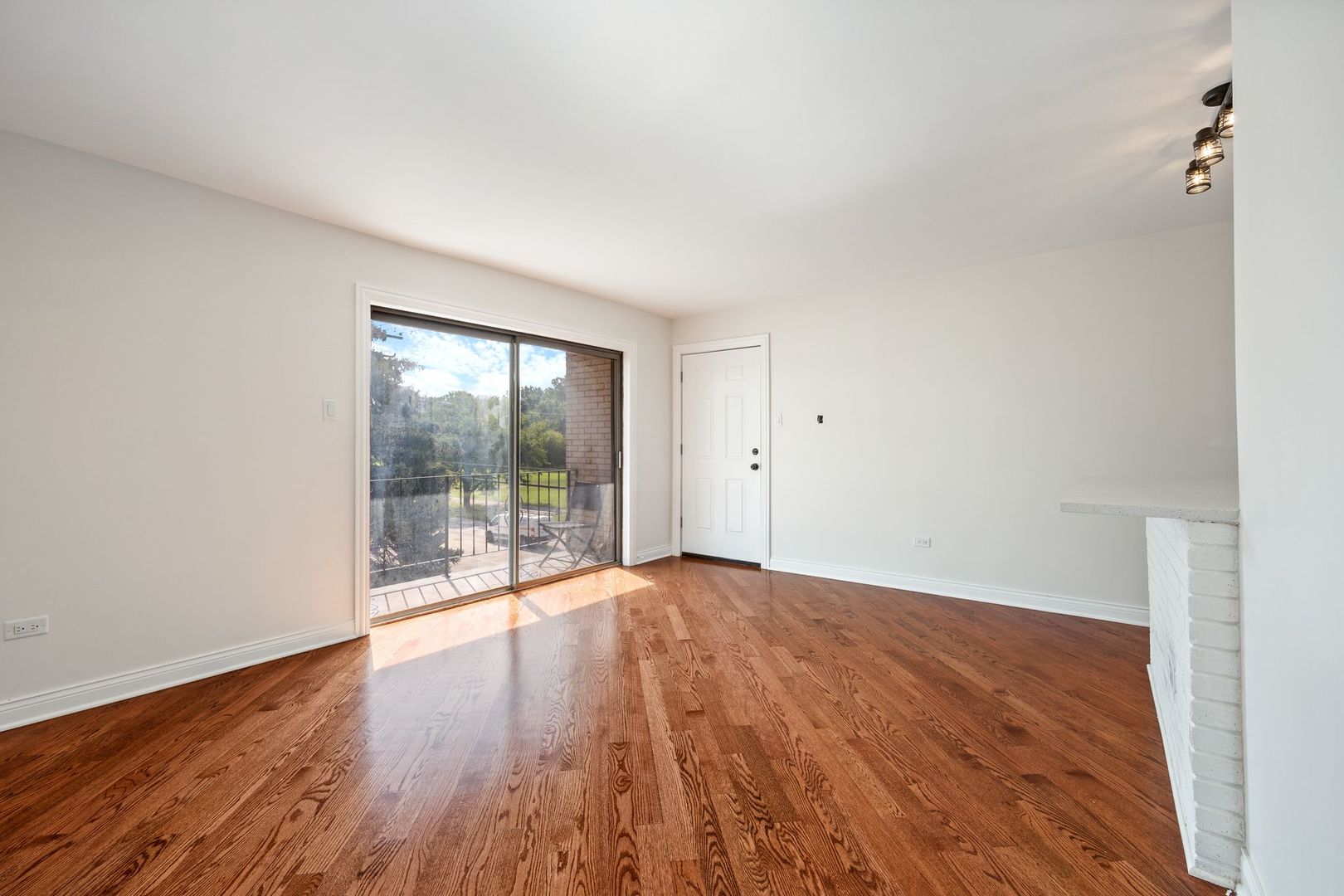 6332 Pershing Road, Unit 3C Berwyn, IL 60402 - Photo 4 of 16 wooden floor in an empty room with a window