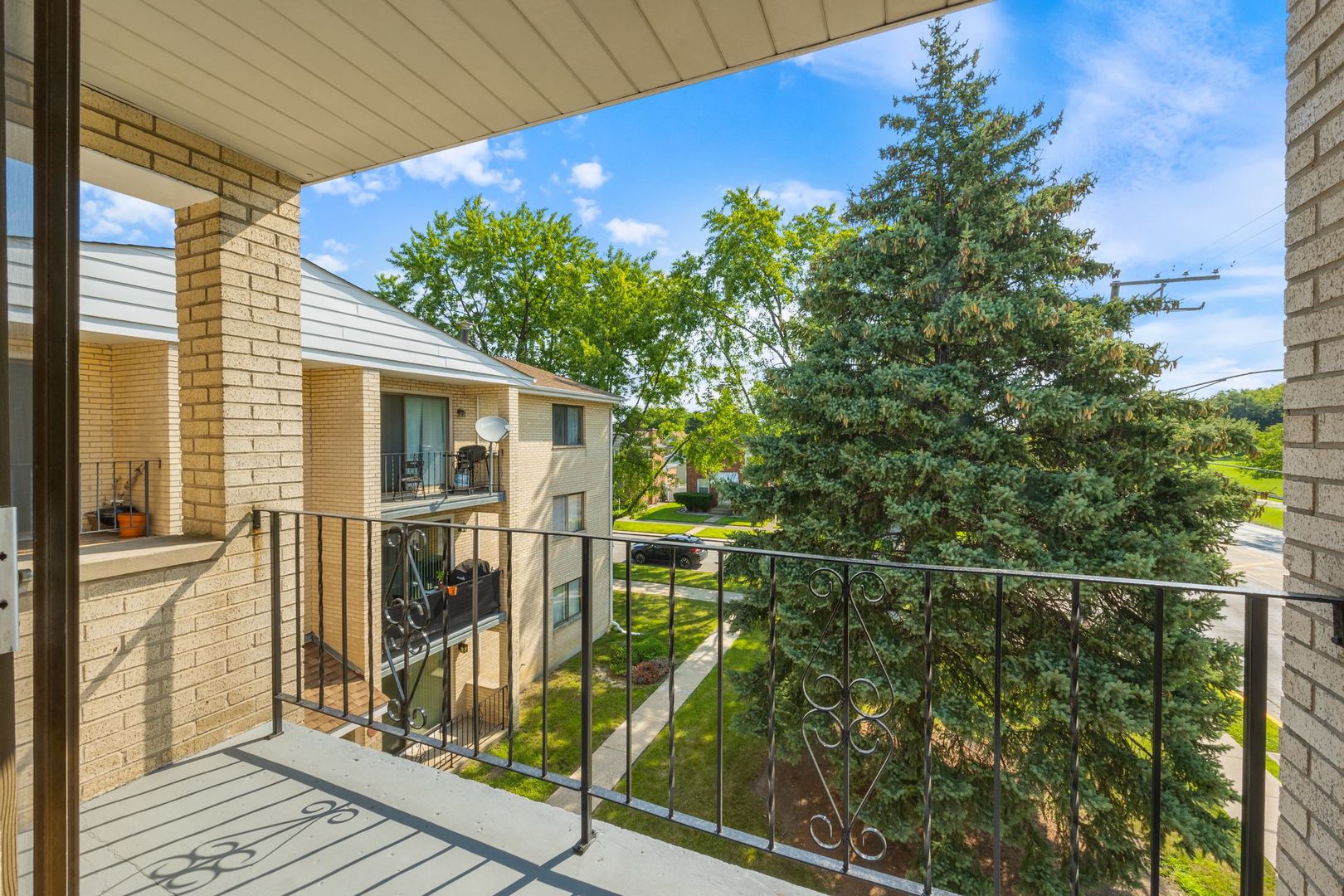 6332 Pershing Road, Unit 3C Berwyn, IL 60402 - Photo 5 of 16 a view of a balcony with floor to ceiling window and wooden floor