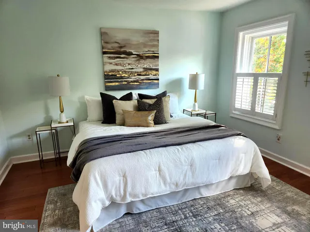 a bathroom with a granite countertop sink a toilet and mirror