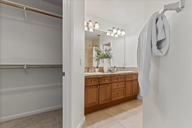 a bathroom with a double vanity sink and a mirror