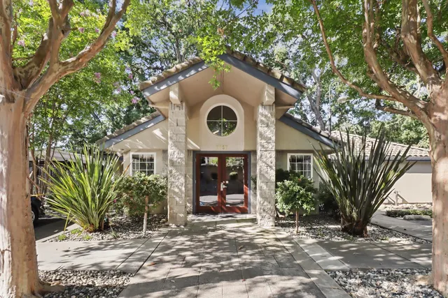 a front view of a house with garden