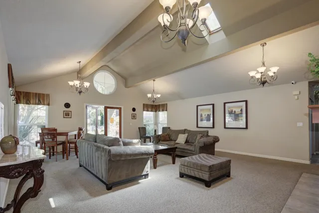 a living room with furniture chandelier and a chandelier