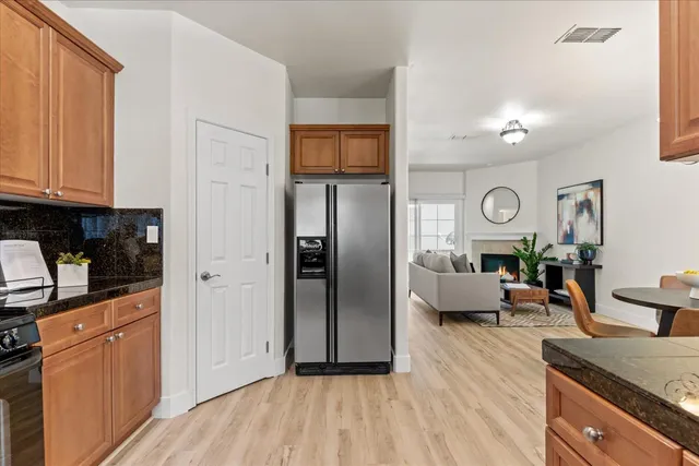 a view of a kitchen with furniture and wooden floor