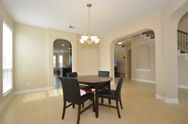 a dining room with furniture and window