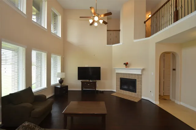 a living room with furniture fireplace and flat screen tv