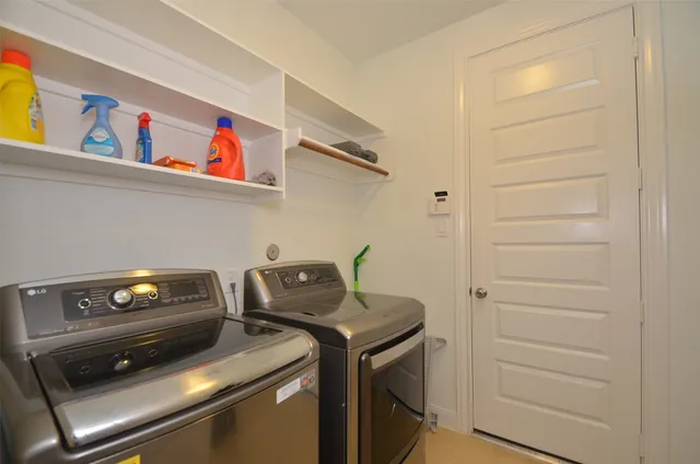 a view of storage and utility room with washer and dryer