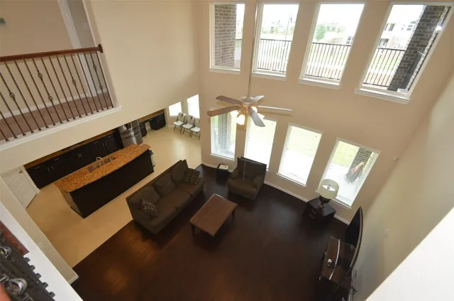 a living room with furniture and a floor to ceiling window