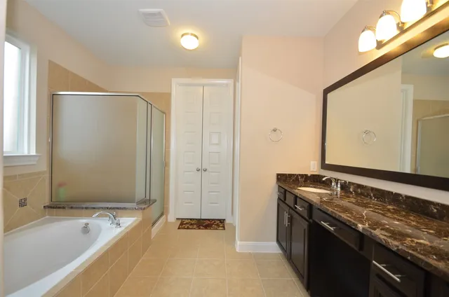 a bathroom with a bathtub and a shower