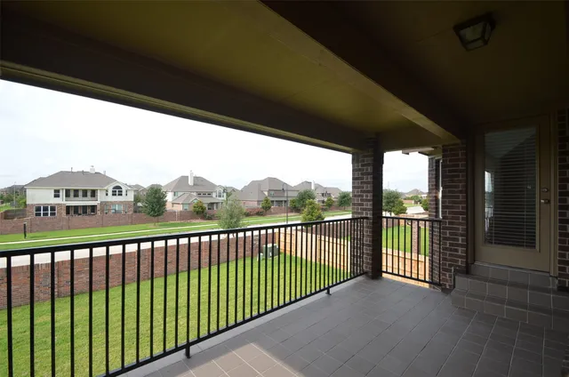 a view of a balcony with floor to ceiling window