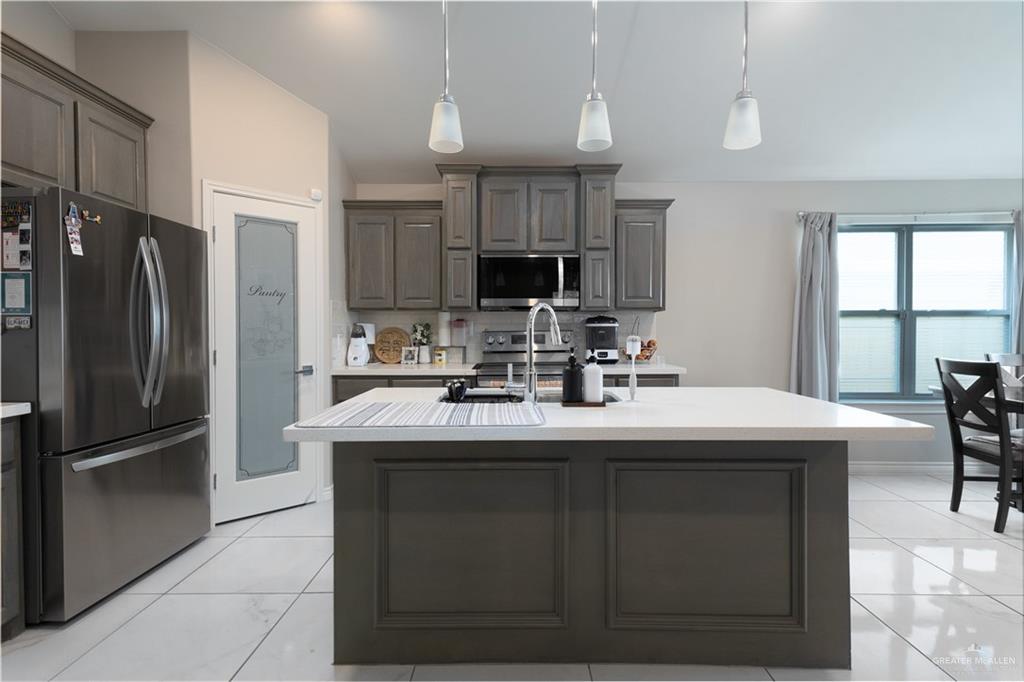 2201 North 26th Drive Hidalgo, TX 78557 - Photo 4 of 12 a kitchen with kitchen island a sink and a refrigerator