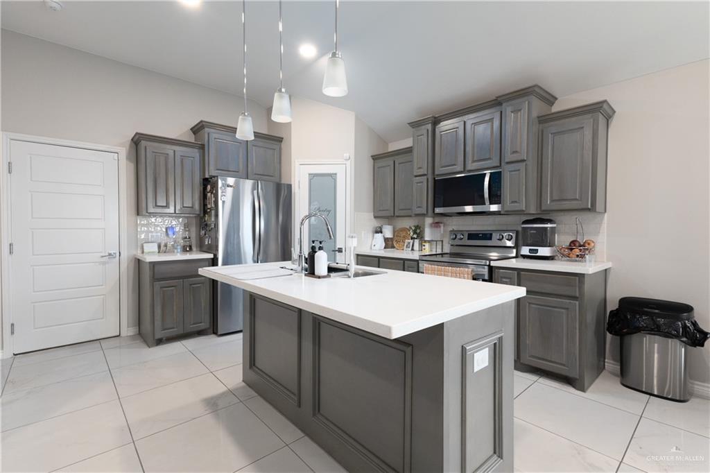 2201 North 26th Drive Hidalgo, TX 78557 - Photo 5 of 12 a kitchen with a sink a stove a refrigerator and cabinets