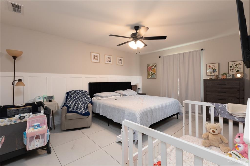 2201 North 26th Drive Hidalgo, TX 78557 - Photo 6 of 12 a bedroom with bed and a chandelier