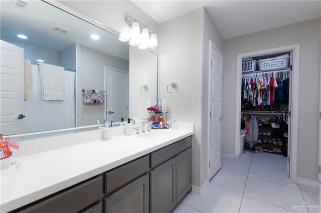 a bathroom with a sink double vanity and a mirror