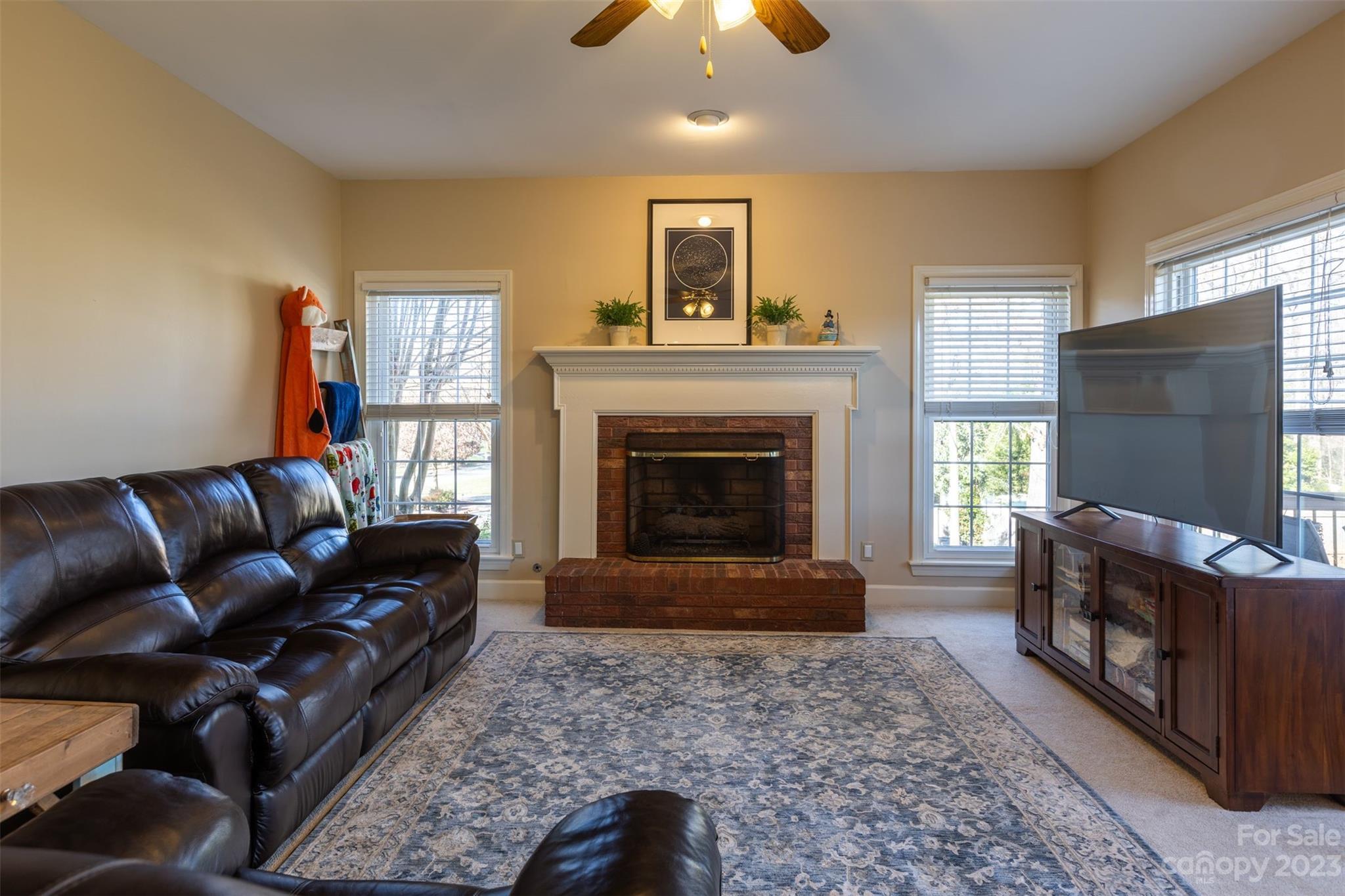 1378 Braeburn Road Northwest Concord, NC 28027 - Photo 11 of 36 a living room with furniture and a fireplace
