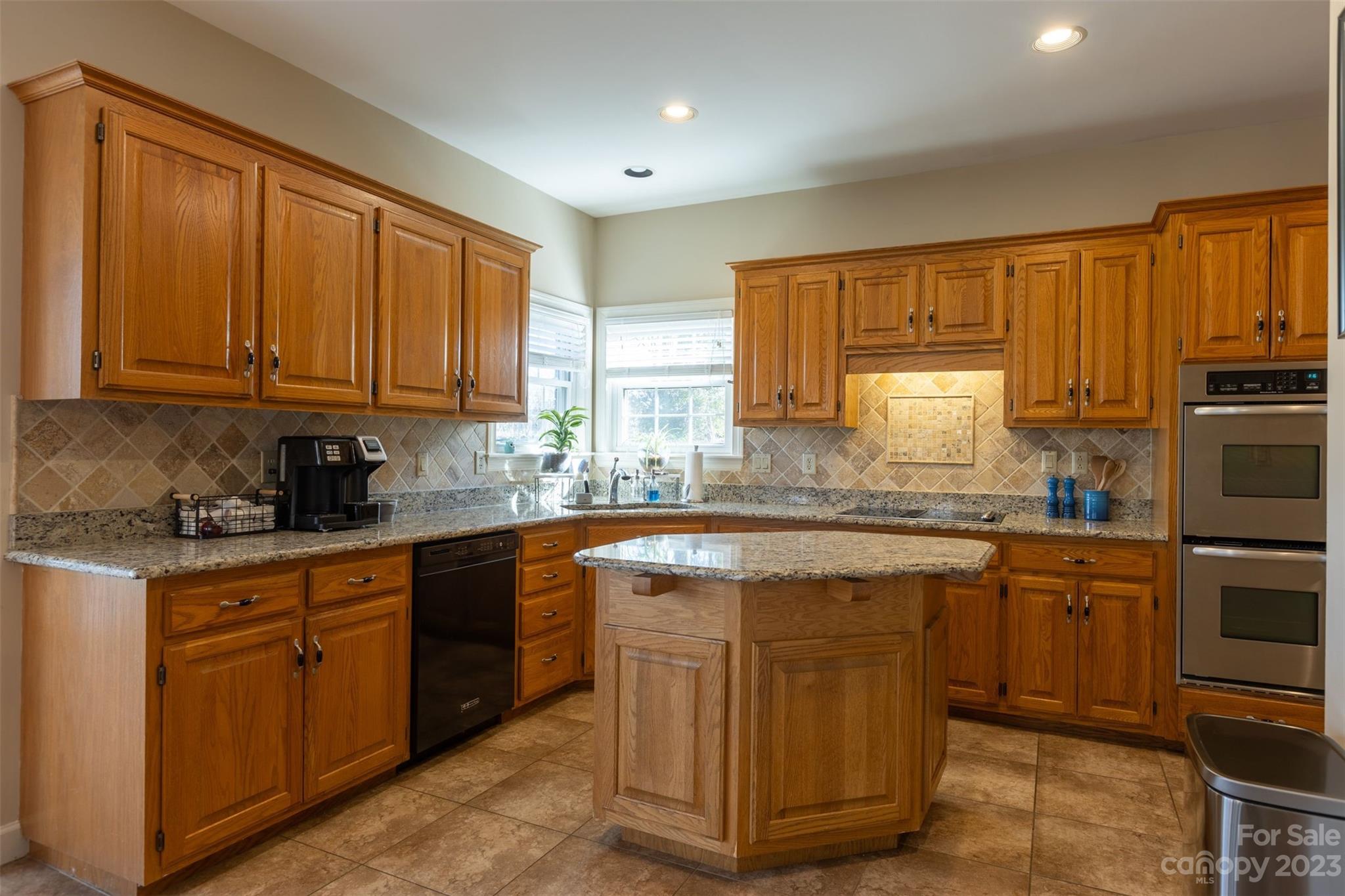 1378 Braeburn Road Northwest Concord, NC 28027 - Photo 14 of 36 a kitchen with stainless steel appliances granite countertop a stove a sink dishwasher and a refrigerator