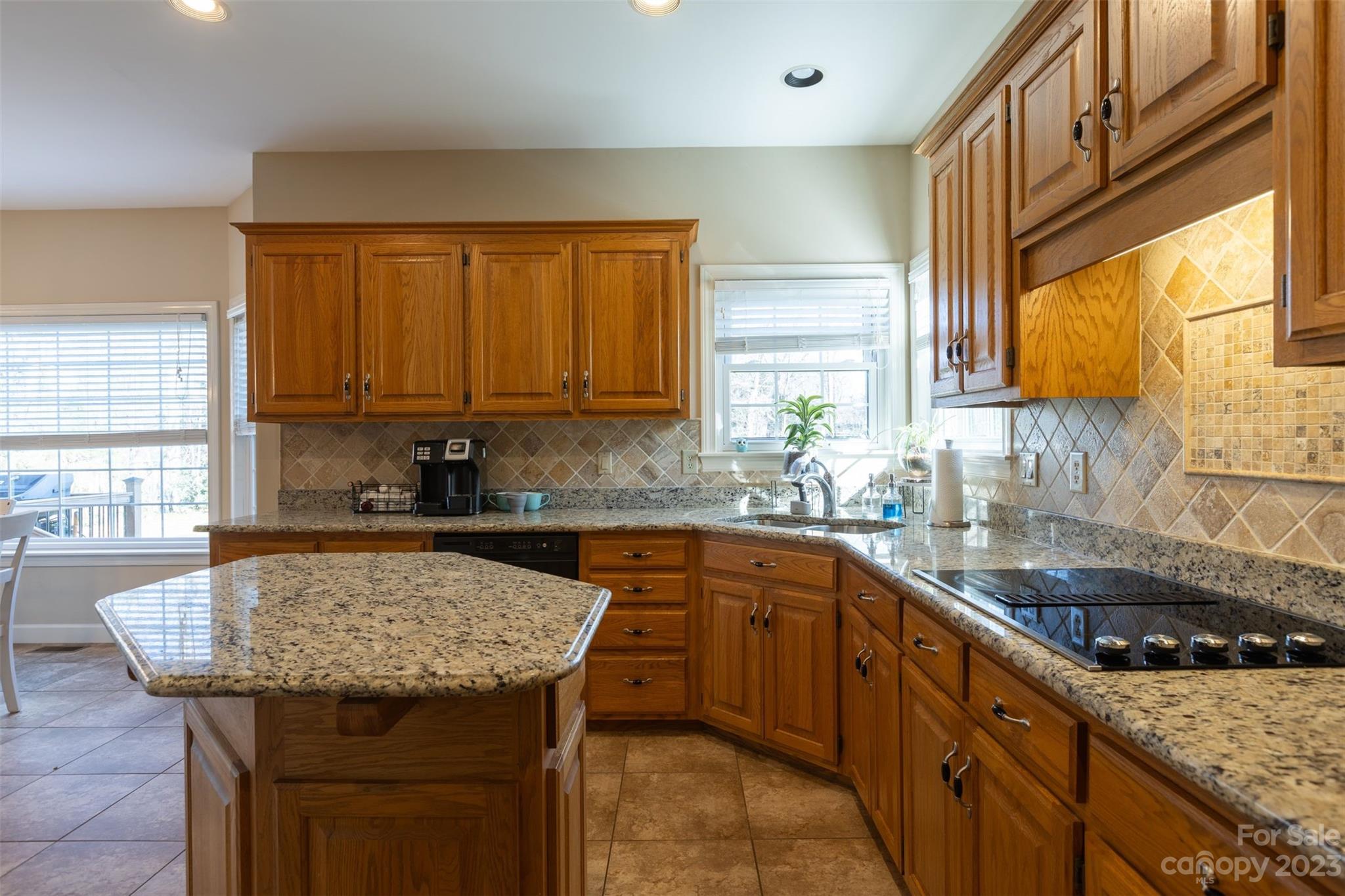 1378 Braeburn Road Northwest Concord, NC 28027 - Photo 15 of 36 a kitchen with granite countertop sink stove and cabinets
