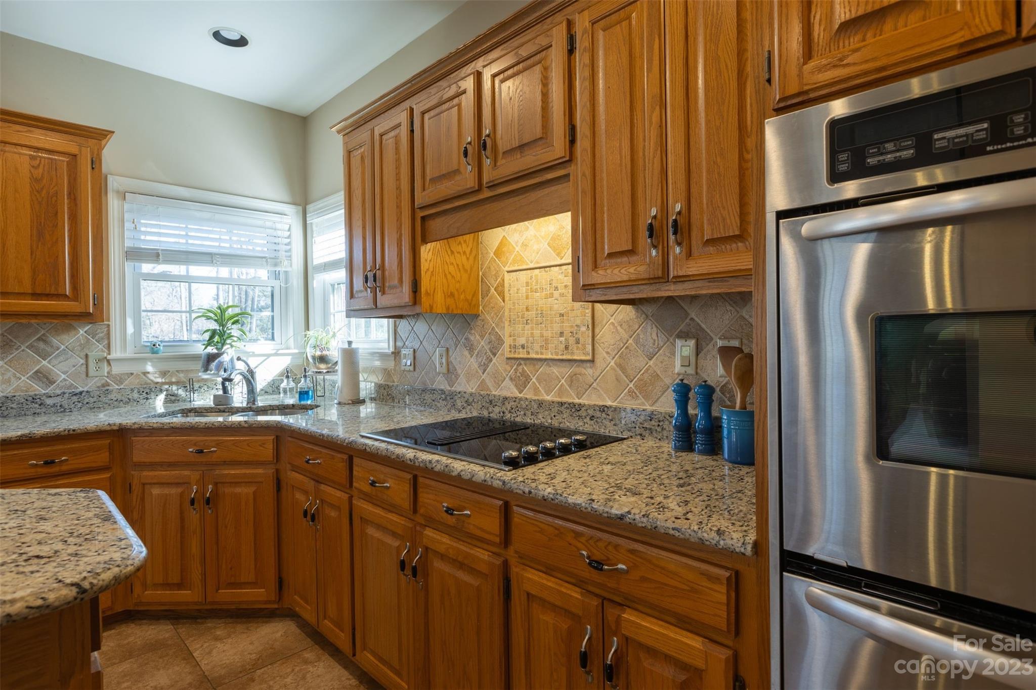1378 Braeburn Road Northwest Concord, NC 28027 - Photo 16 of 36 a kitchen with granite countertop stainless steel appliances and sink