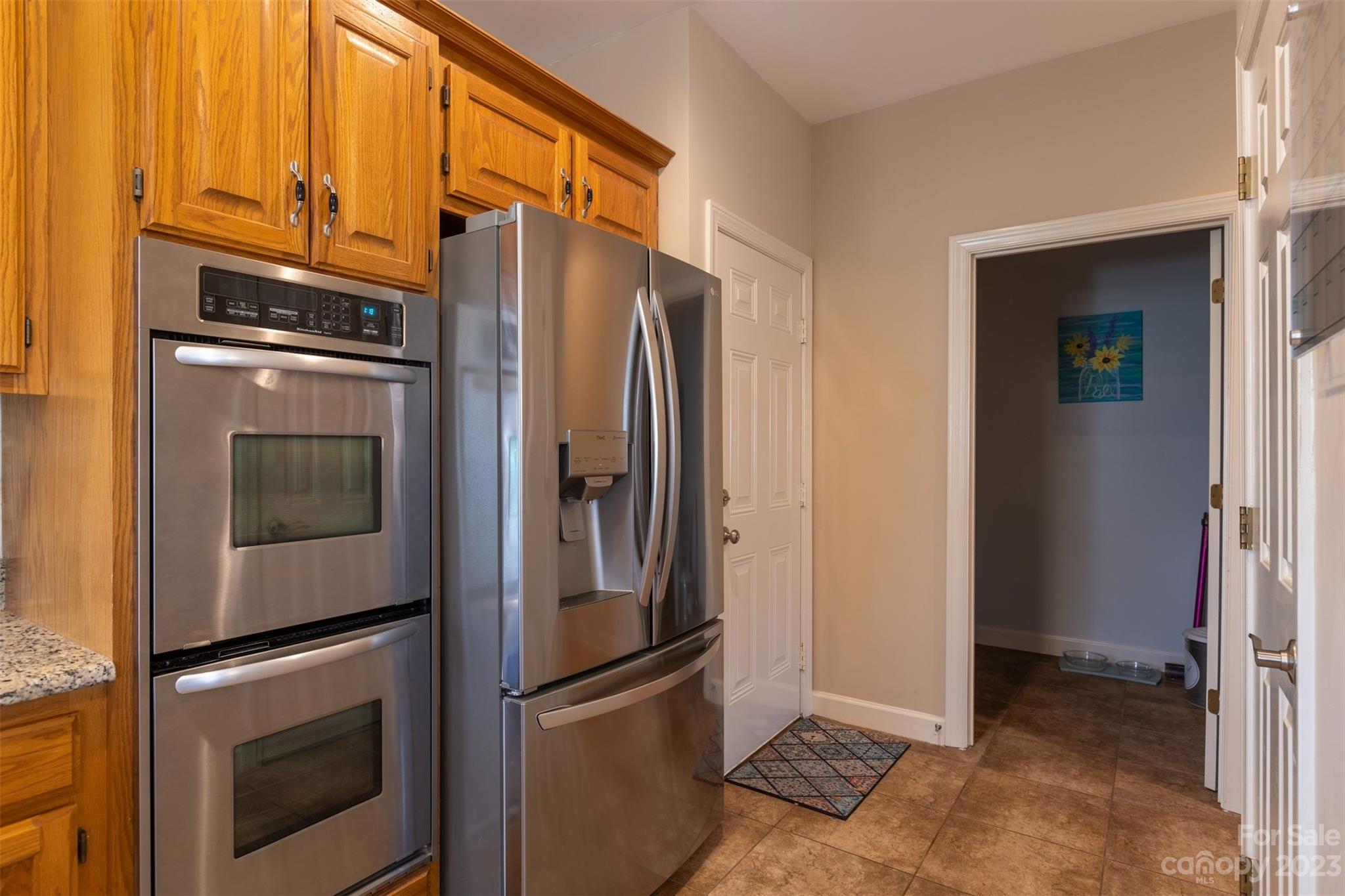 1378 Braeburn Road Northwest Concord, NC 28027 - Photo 17 of 36 a metallic refrigerator freezer and a stove sitting inside of a kitchen