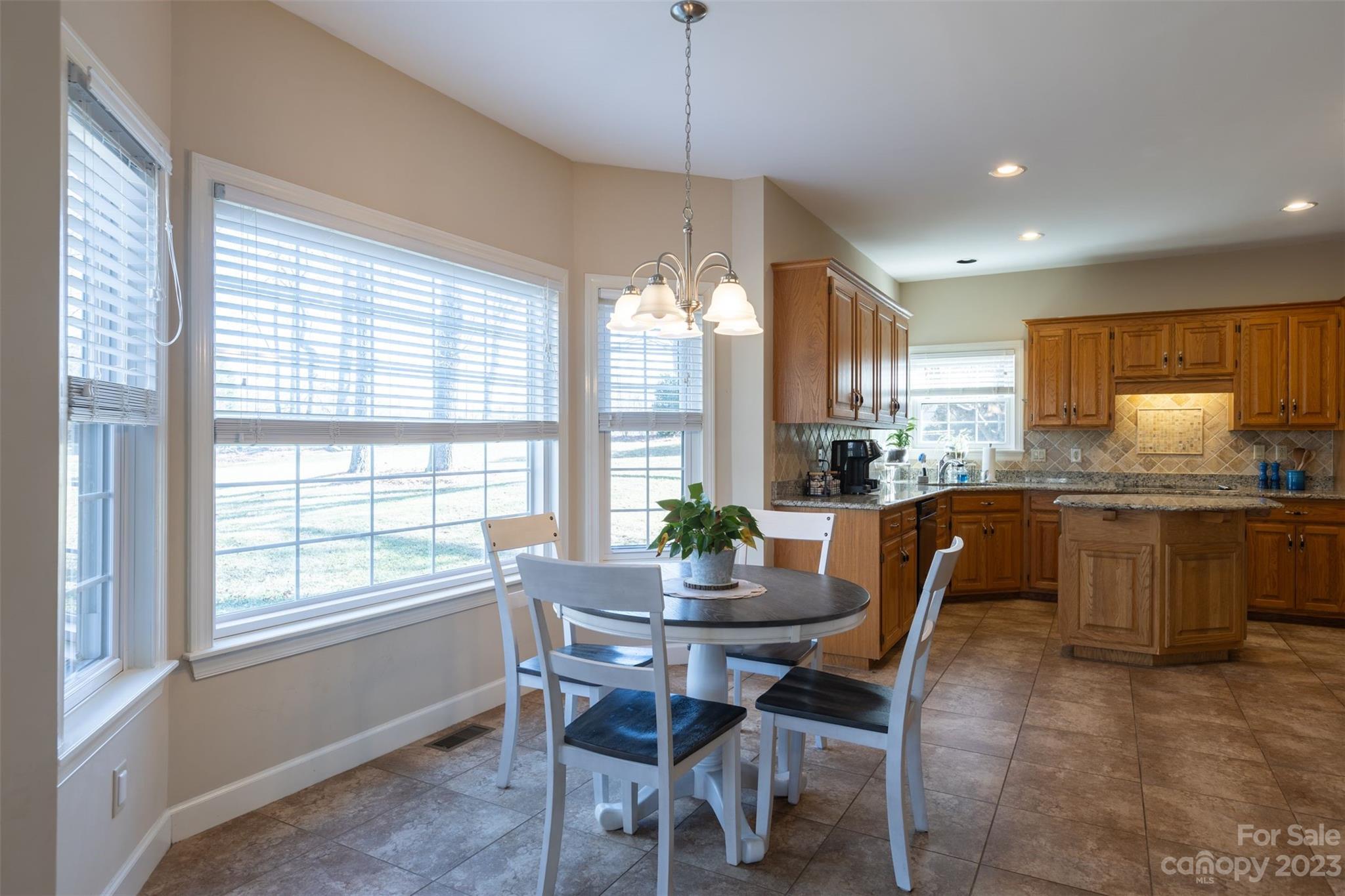 1378 Braeburn Road Northwest Concord, NC 28027 - Photo 19 of 36 a dining room with a table chairs and kitchen view
