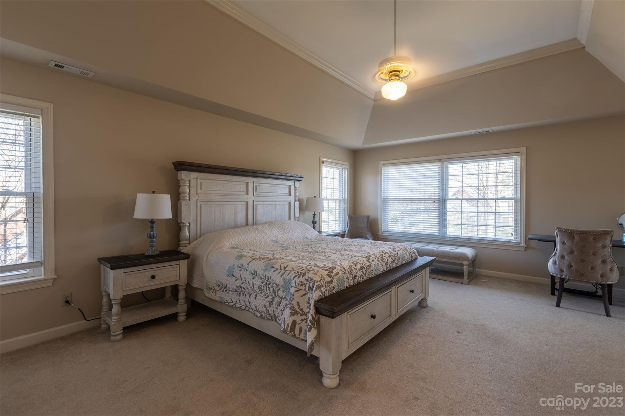 1378 Braeburn Road Northwest Concord, NC 28027 - Photo 22 of 36 a bedroom with a bed and a chandelier