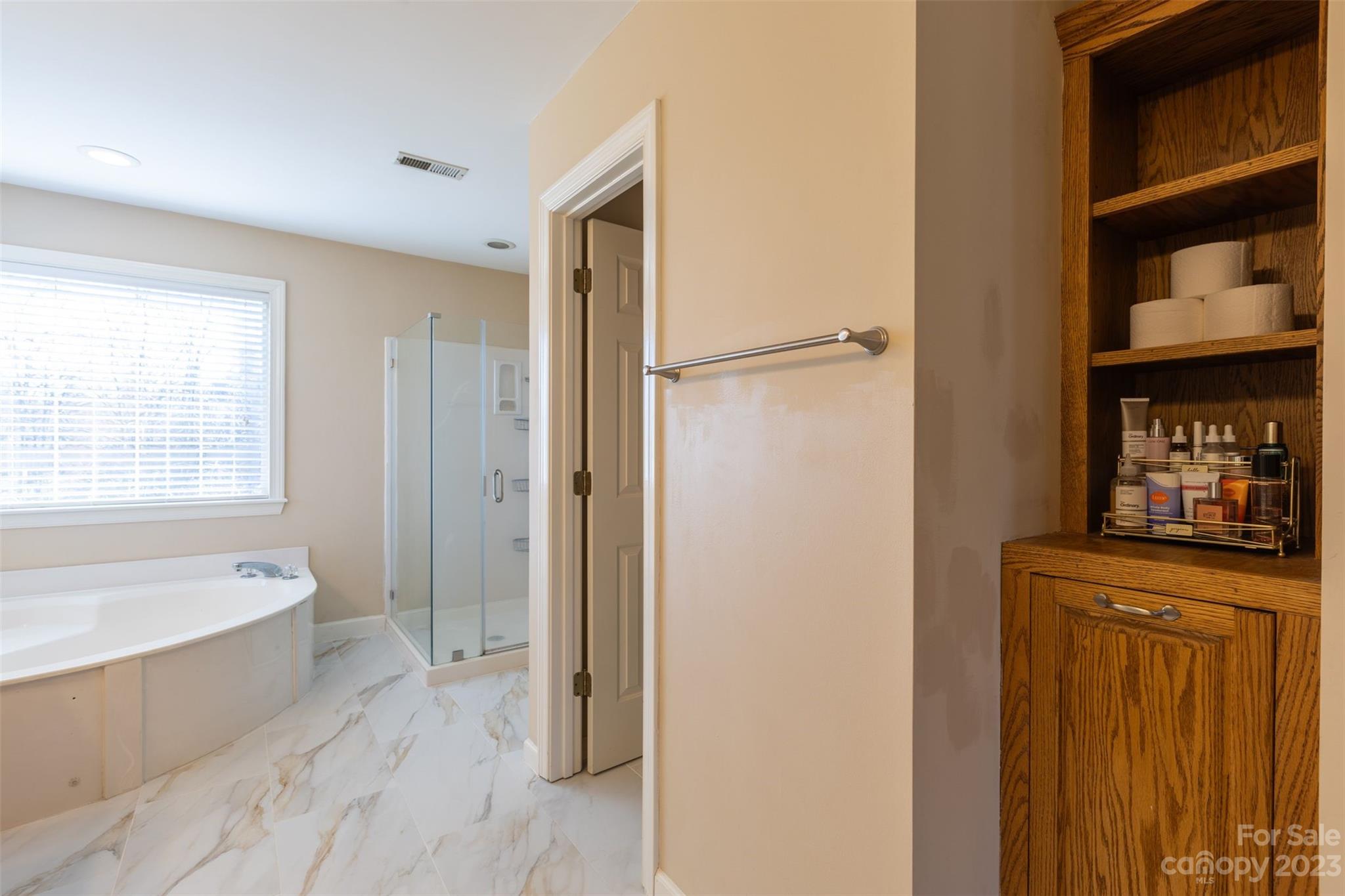 1378 Braeburn Road Northwest Concord, NC 28027 - Photo 26 of 36 a spacious bathroom with a bathtub and a shower