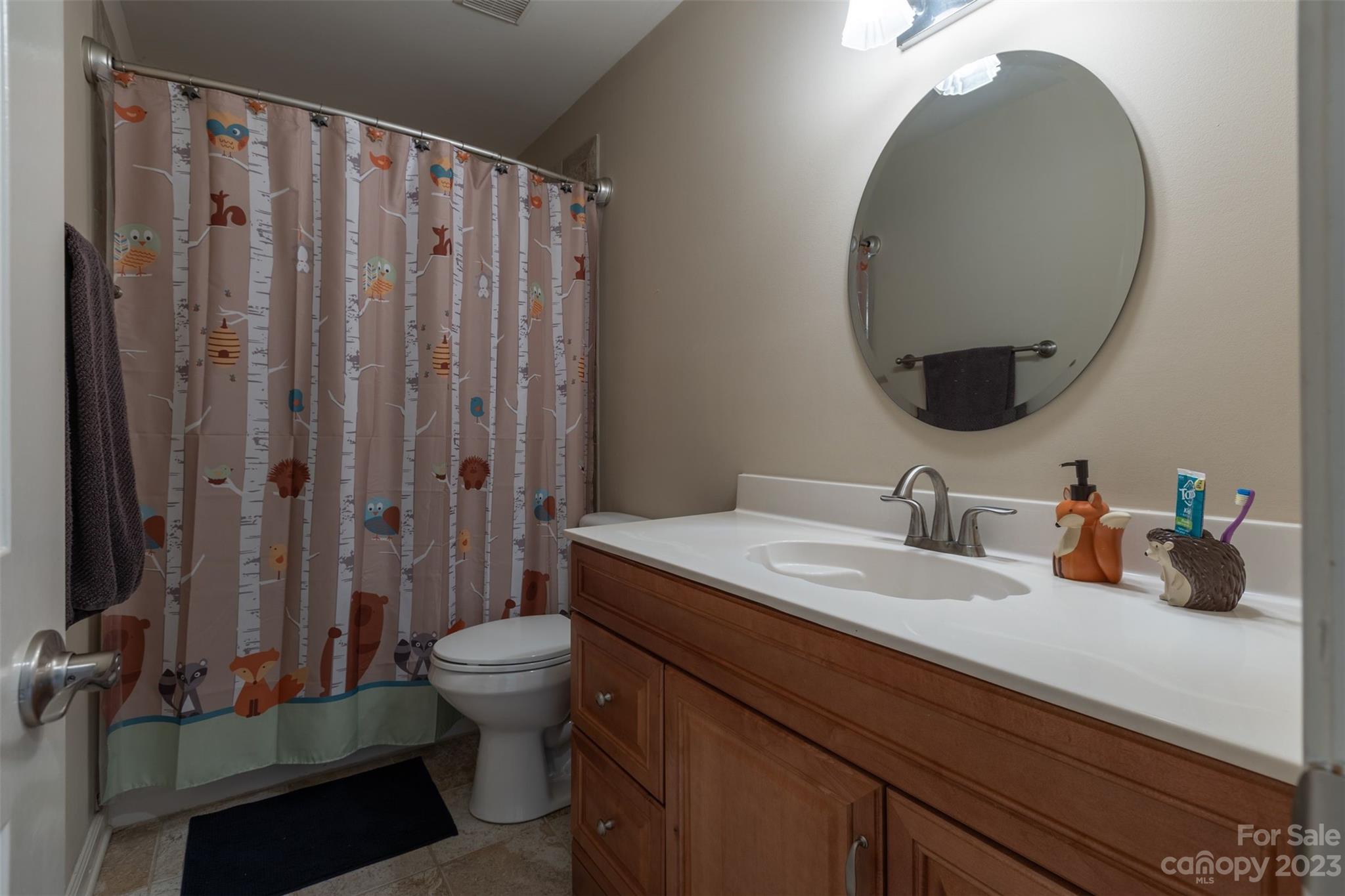 1378 Braeburn Road Northwest Concord, NC 28027 - Photo 30 of 36 a bathroom with a sink a toilet and a mirror