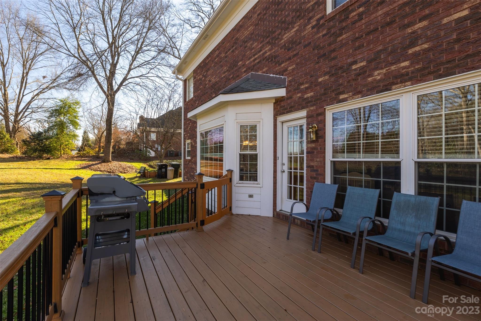 1378 Braeburn Road Northwest Concord, NC 28027 - Photo 33 of 36 a view of a deck with table and chairs and wooden floor
