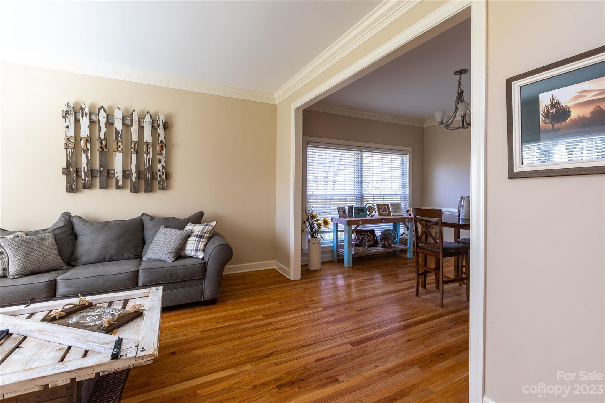 1378 Braeburn Road Northwest Concord, NC 28027 - Photo 8 of 36 a living room with furniture and a wooden floor