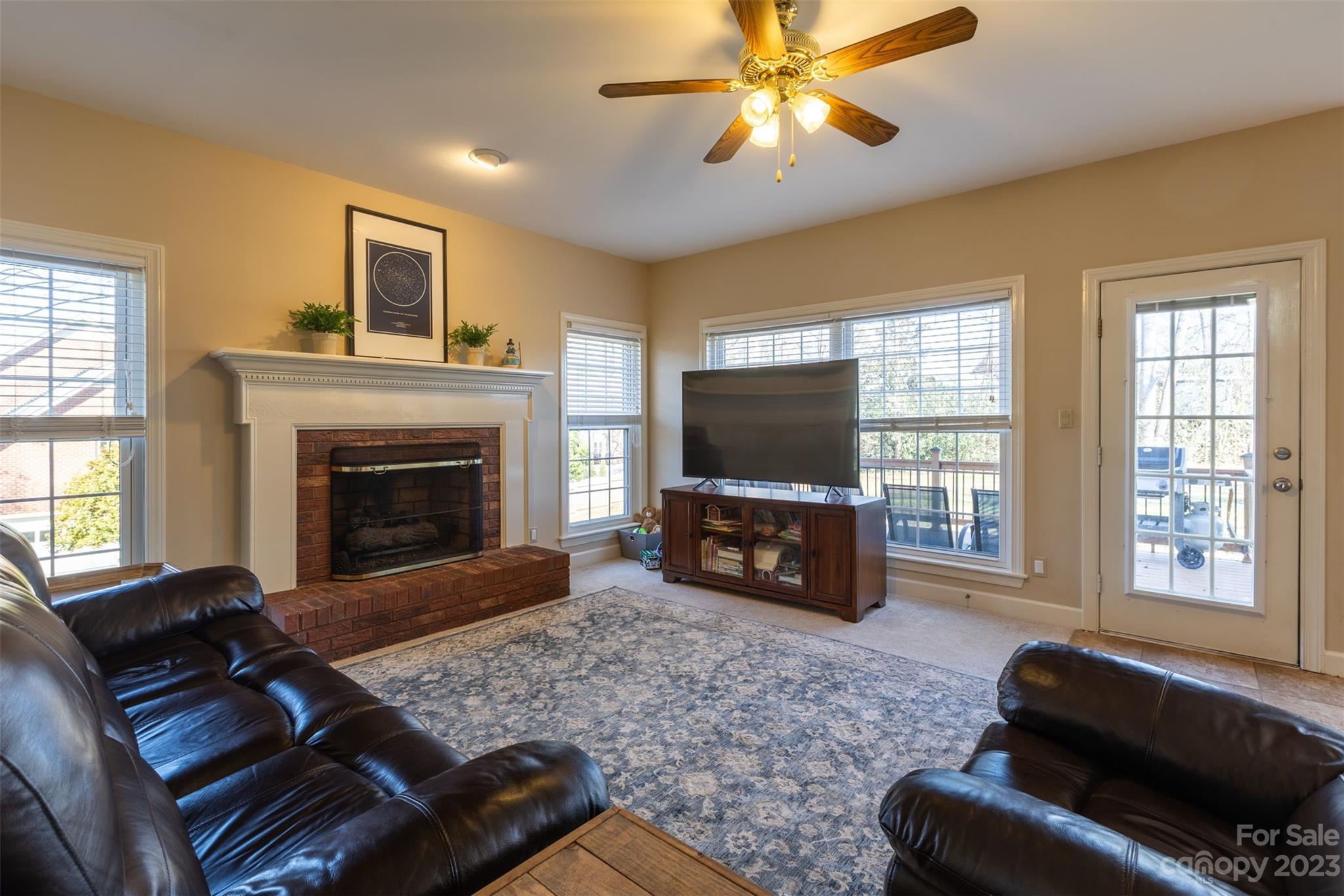1378 Braeburn Road Northwest Concord, NC 28027 - Photo 10 of 36 a living room with furniture a flat screen tv and a fireplace