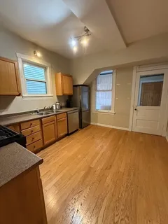 a large kitchen with a stove a sink dishwasher and a refrigerator