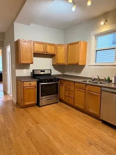 a kitchen with stainless steel appliances granite countertop a stove a sink and a microwave