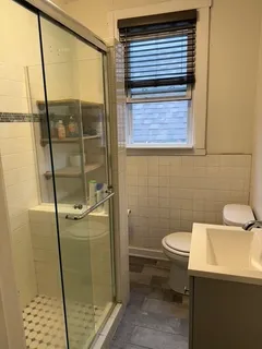 a bathroom with a toilet and a shower
