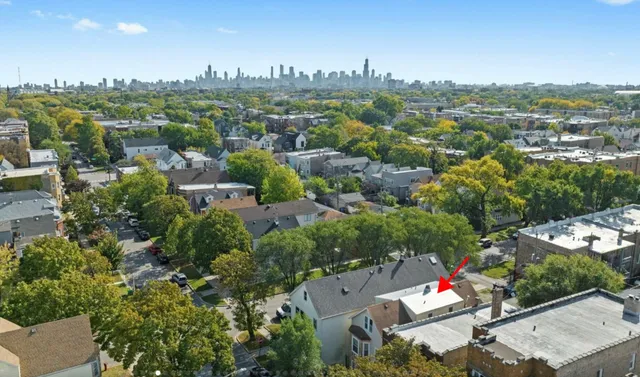an aerial view of residential houses with city view