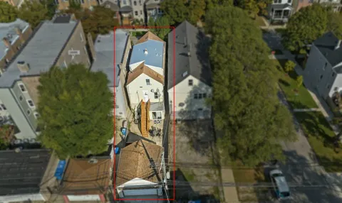 an aerial view of residential houses with outdoor space