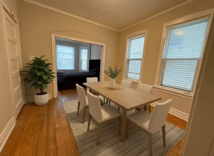 a view of a dining room with furniture and wooden floor