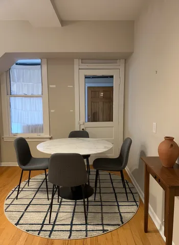 a view of a dining room with furniture and wooden floor