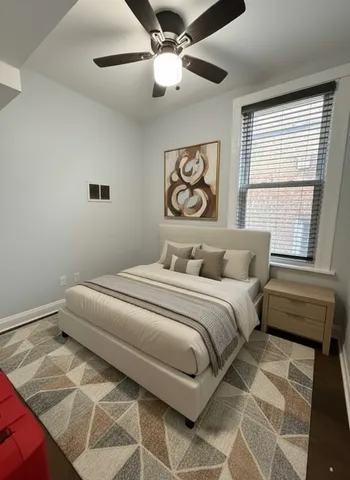 a bedroom with a bed and a window