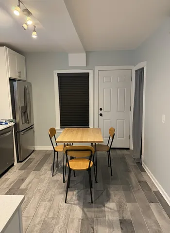 a dining room with furniture and wooden floor
